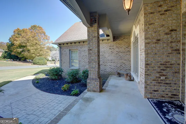 a view of a brick house with a yard