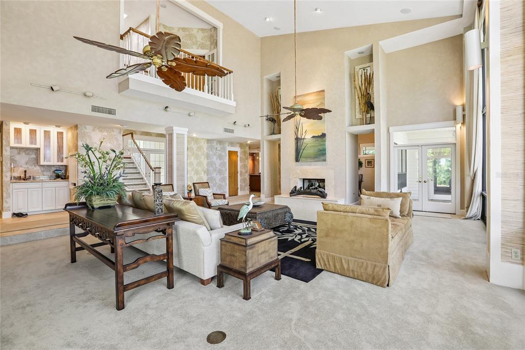 17810 Crawley Road Odessa, FL 33556 - Photo 11 of 76 a living room with furniture a chandelier and a dining table