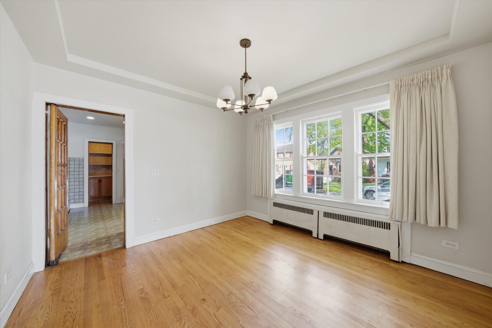 3100 Clinton Avenue Berwyn, IL 60402 - Photo 7 of 25 an empty room with wooden floor fan and windows