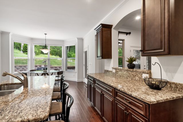a kitchen with counter top space a sink cabinets and appliances