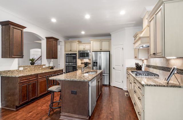 a kitchen with stainless steel appliances granite countertop a stove and a sink
