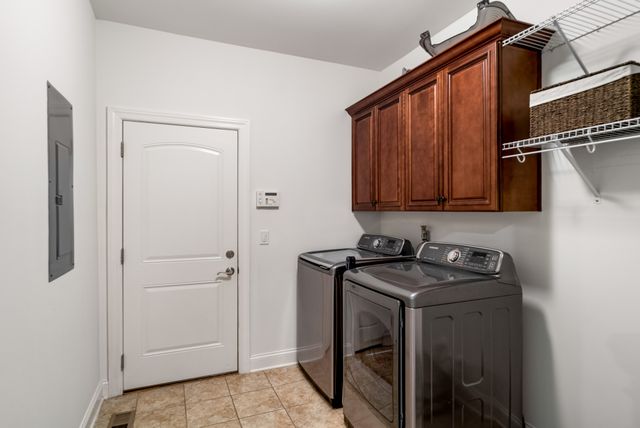 a utility room with sink dryer and washer