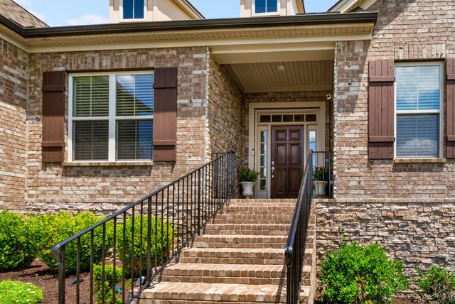 a front view of a house with a garden