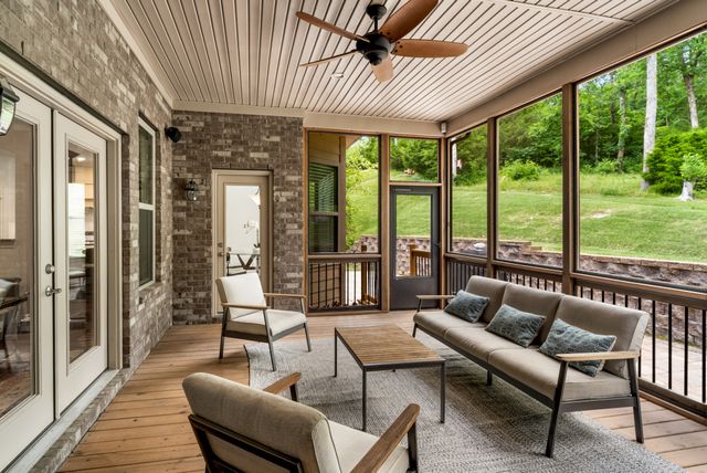 a living room with furniture and a floor to ceiling window