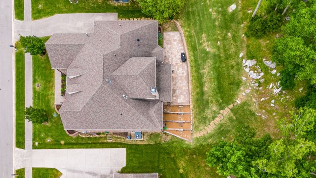 an aerial view of a house with a yard and garden