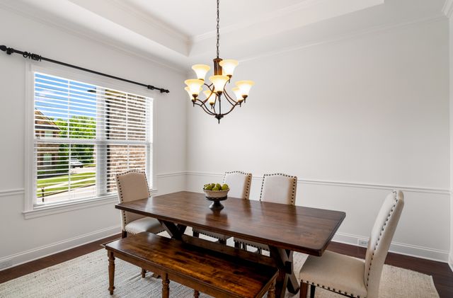 a view of a dining room with a table and chairs