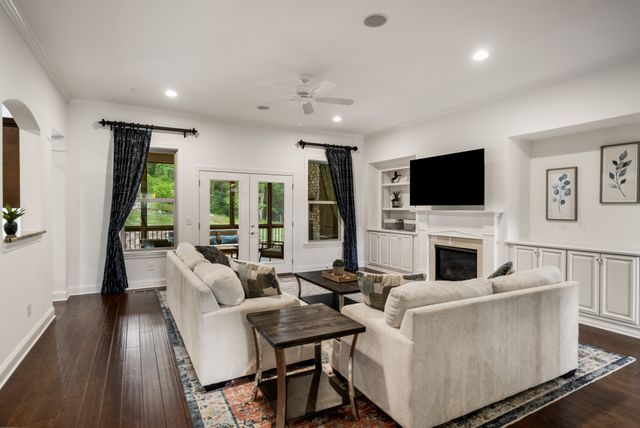 a living room with furniture a fireplace and a flat screen tv