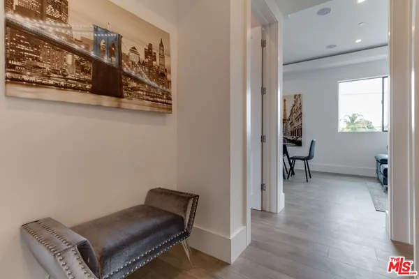 a living room with furniture and large windows