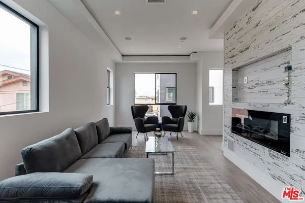 a kitchen with a table chairs refrigerator and cabinets
