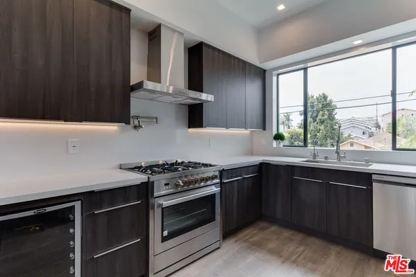 a kitchen with stainless steel appliances a stove microwave and cabinets