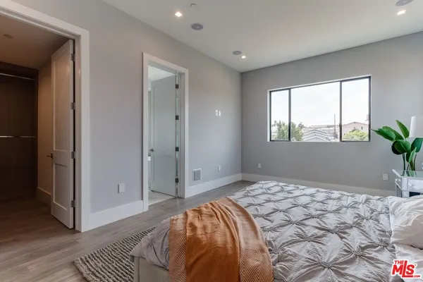 a bedroom with a bed and a lamp