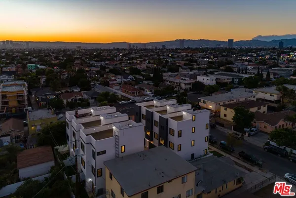 a view of houses with a street