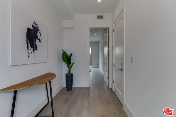 a bedroom with a bed and a mirror