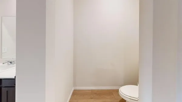 a white toilet sitting next to a shower