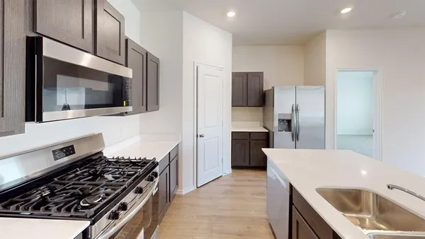 a kitchen with a refrigerator stove and microwave