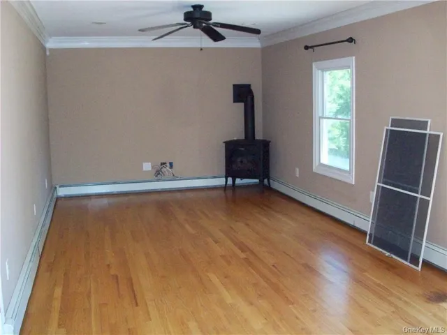 a view of room with hardwood floor and window