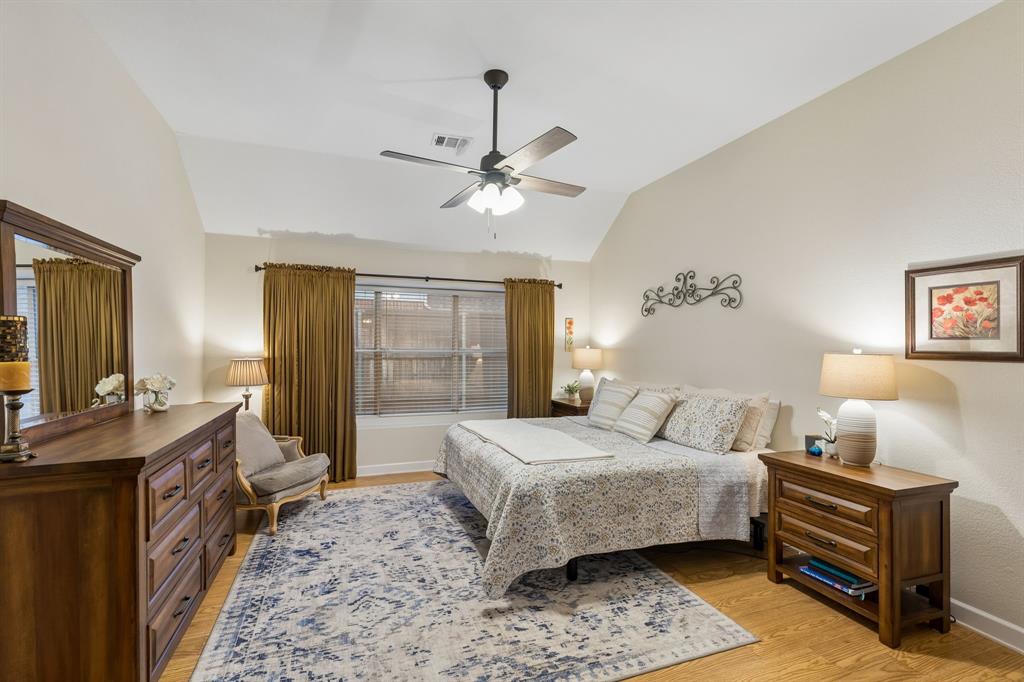 915 Rutgers Court Allen, TX 75002 - Photo 19 of 39 The spacious primary bedroom is separated from the secondary bedrooms and enjoys the privacy of being toward the back of the home. High ceilings add to the open and airy feel of the room.