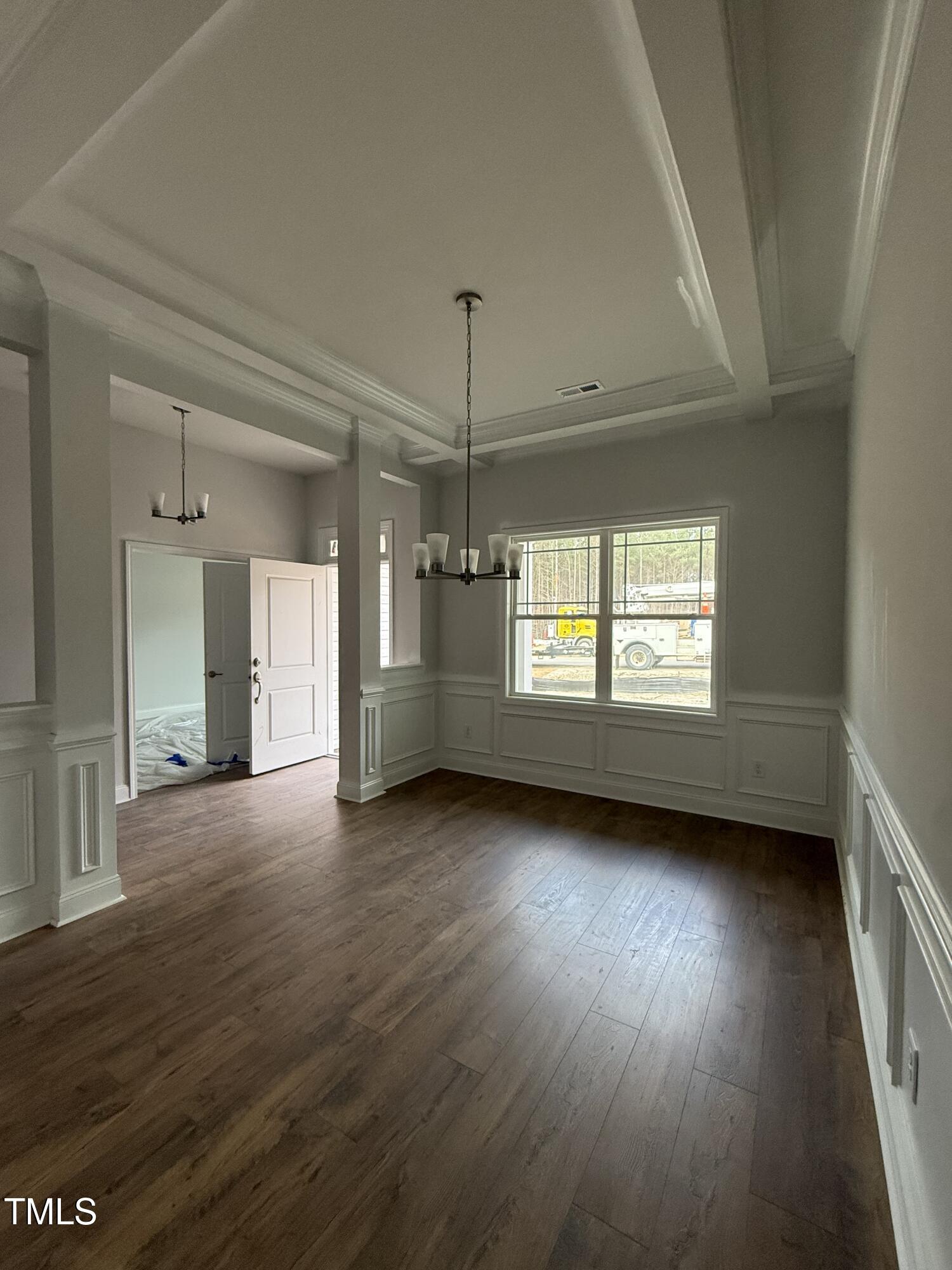 a view of a room window and wooden floor