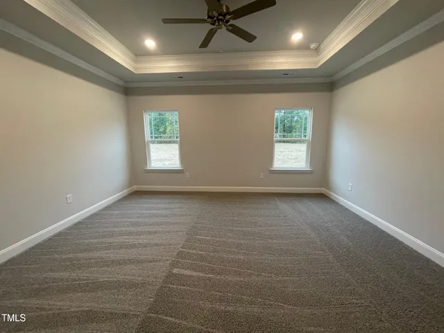 an empty room with windows and closet