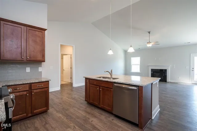 a kitchen with a sink and a stove top oven