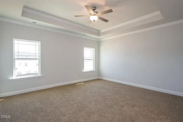 an empty room with a window and a ceiling fan