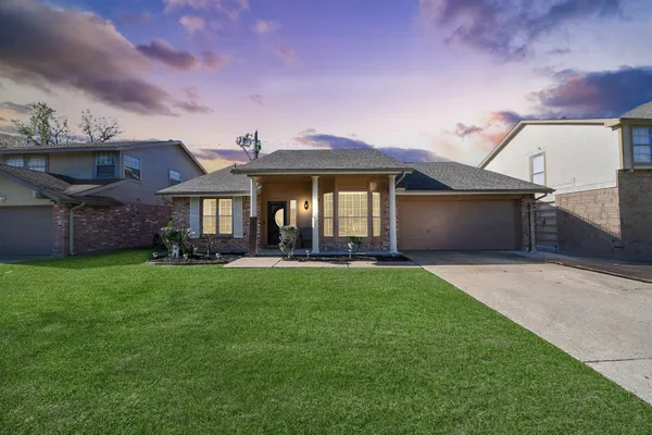 a front view of a house with a garden