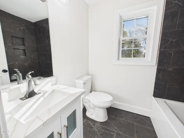 a bathroom with a sink toilet and a tub