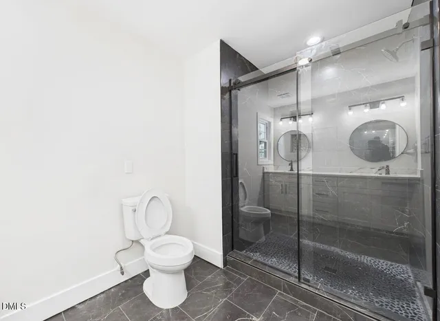 a bathroom with a toilet a sink and a shower