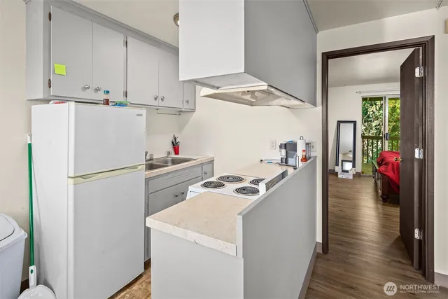 a white refrigerator freezer sitting inside of a kitchen