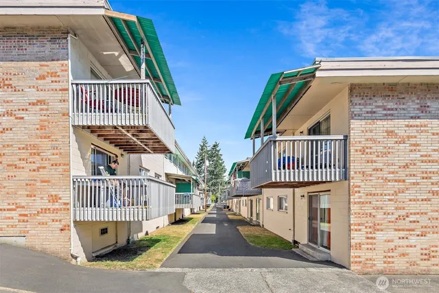 a view of a brick house with wooden fence