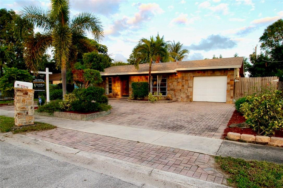 22288 Southwest 63rd Avenue Boca Raton, FL 33428 - Photo 3 of 16 front view of a house with a yard and a garage