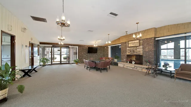 a view of a livingroom with furniture a fireplace and window
