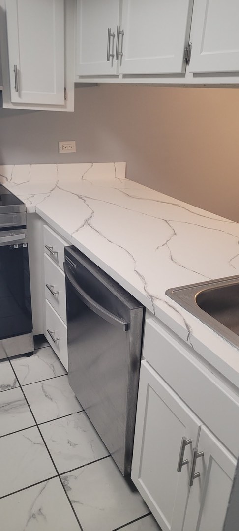 840 Elder Road, Unit A405 Homewood, IL 60430 - Photo 8 of 21 a kitchen with granite countertop a cabinets and a stove top oven