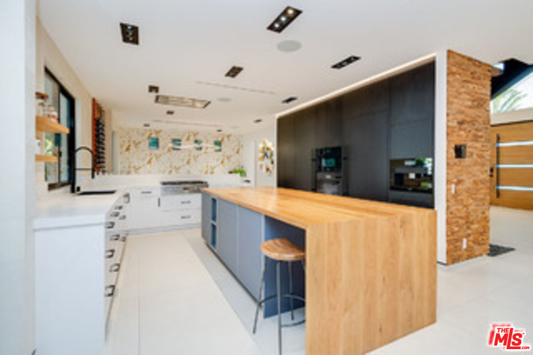 25879 Chalmers Place Calabasas, CA 91302 - Photo 12 of 38 a large white kitchen with a large window