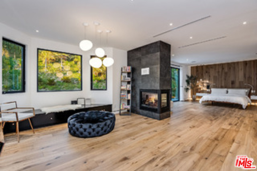 25879 Chalmers Place Calabasas, CA 91302 - Photo 15 of 38 a living room with furniture and a fireplace