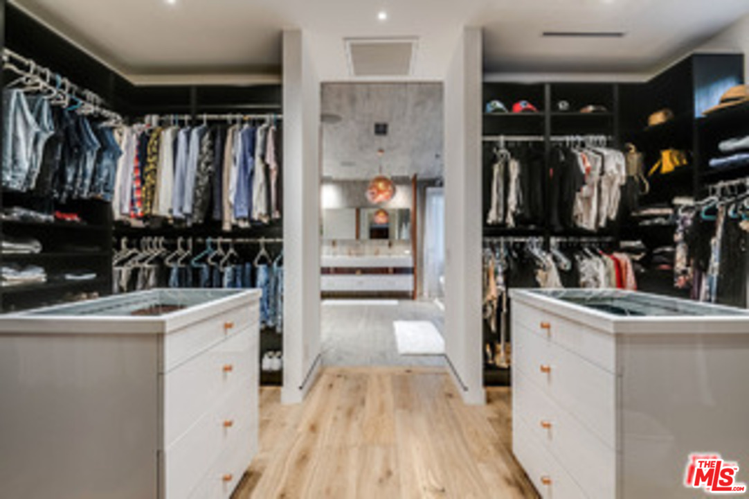 25879 Chalmers Place Calabasas, CA 91302 - Photo 17 of 38 a view of a kitchen with refrigerator and white cabinets