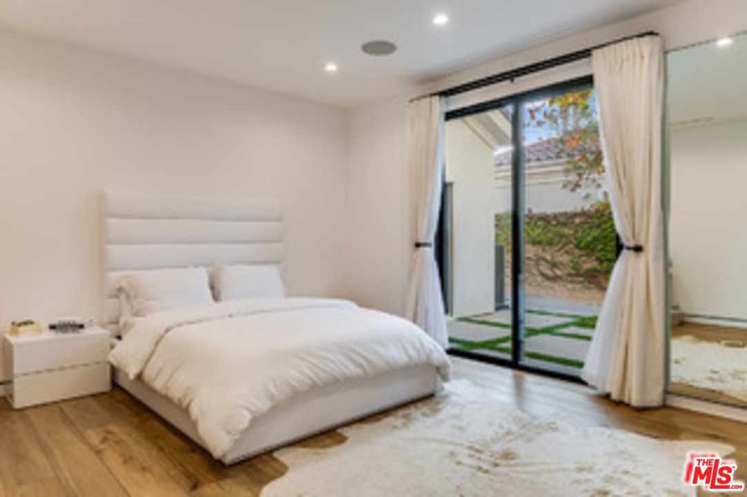 25879 Chalmers Place Calabasas, CA 91302 - Photo 19 of 38 a bedroom with a bed and a large window