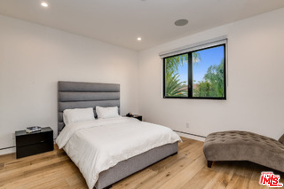 25879 Chalmers Place Calabasas, CA 91302 - Photo 20 of 38 a bedroom with a bed and a painting on the wall