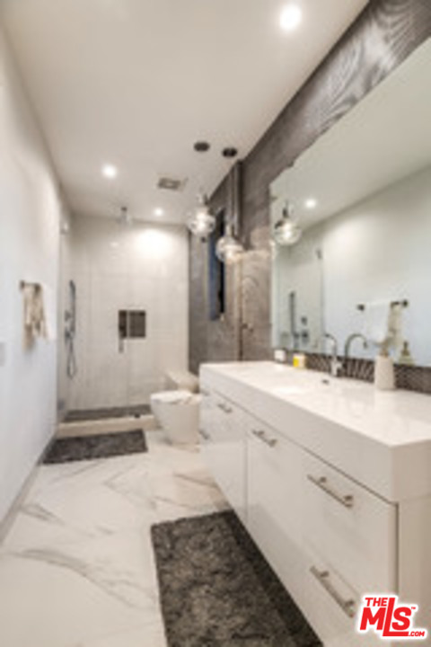 25879 Chalmers Place Calabasas, CA 91302 - Photo 35 of 38 a large white kitchen with a lot of counter space and a sink