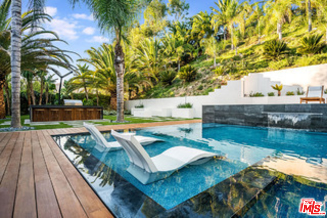 25879 Chalmers Place Calabasas, CA 91302 - Photo 36 of 38 a view of a backyard with swimming pool