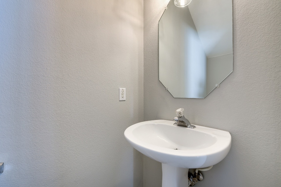 1504 East 19th Street Georgetown, TX 78626 - Photo 15 of 27 a bathroom with a sink and a mirror
