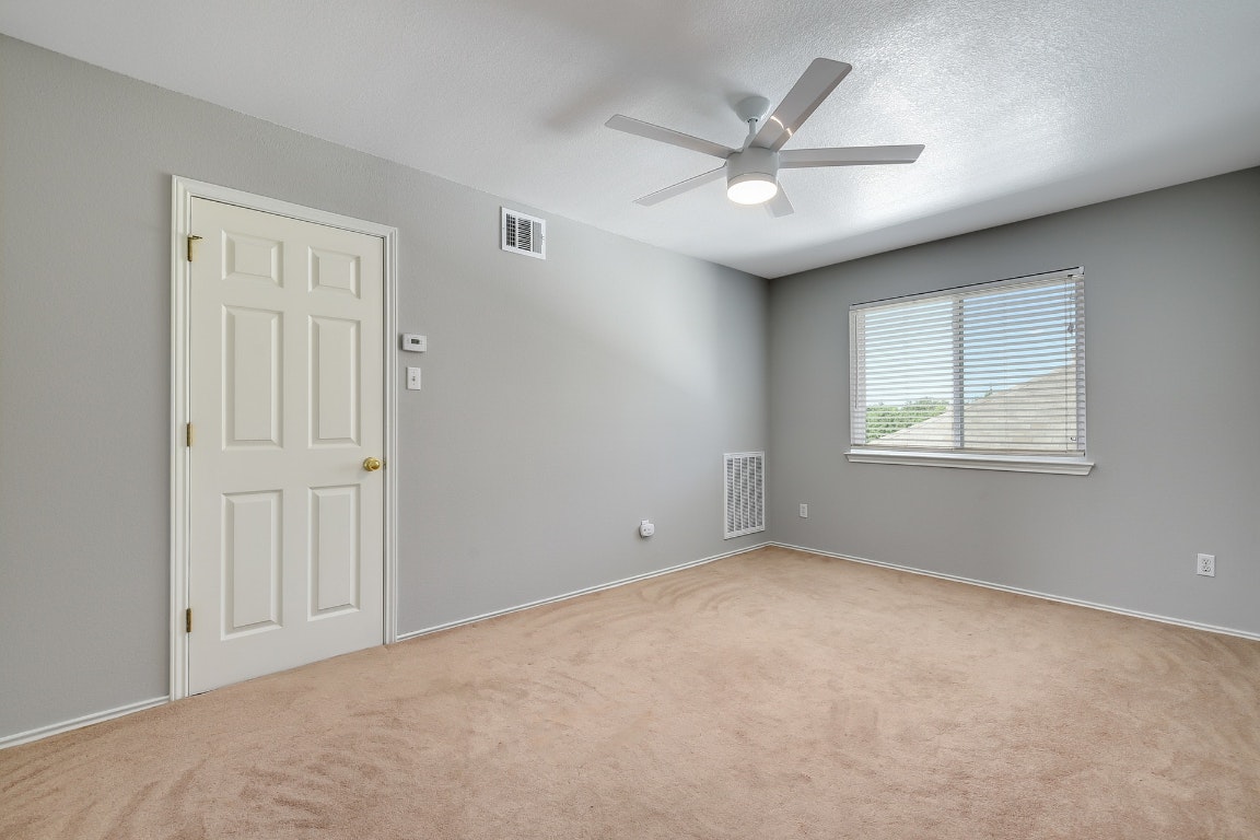 1504 East 19th Street Georgetown, TX 78626 - Photo 19 of 27 an empty room with windows and fan