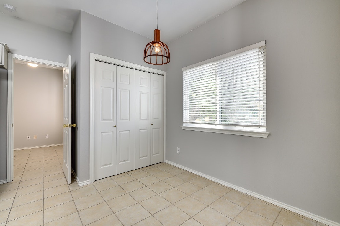 1504 East 19th Street Georgetown, TX 78626 - Photo 8 of 27 a view of an empty room with window and chandelier fan