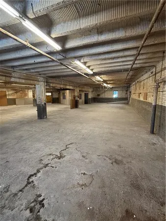 a view of empty room with wooden ceiling