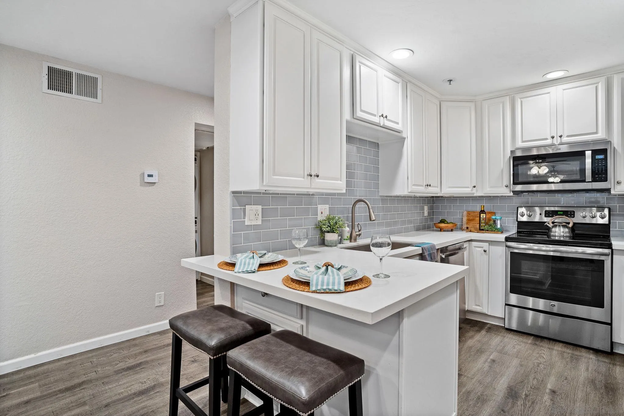 5705 Friars Road, Unit 8 San Diego, CA 92110 - Photo 1 of 26 a kitchen with a sink cabinets and wooden floor