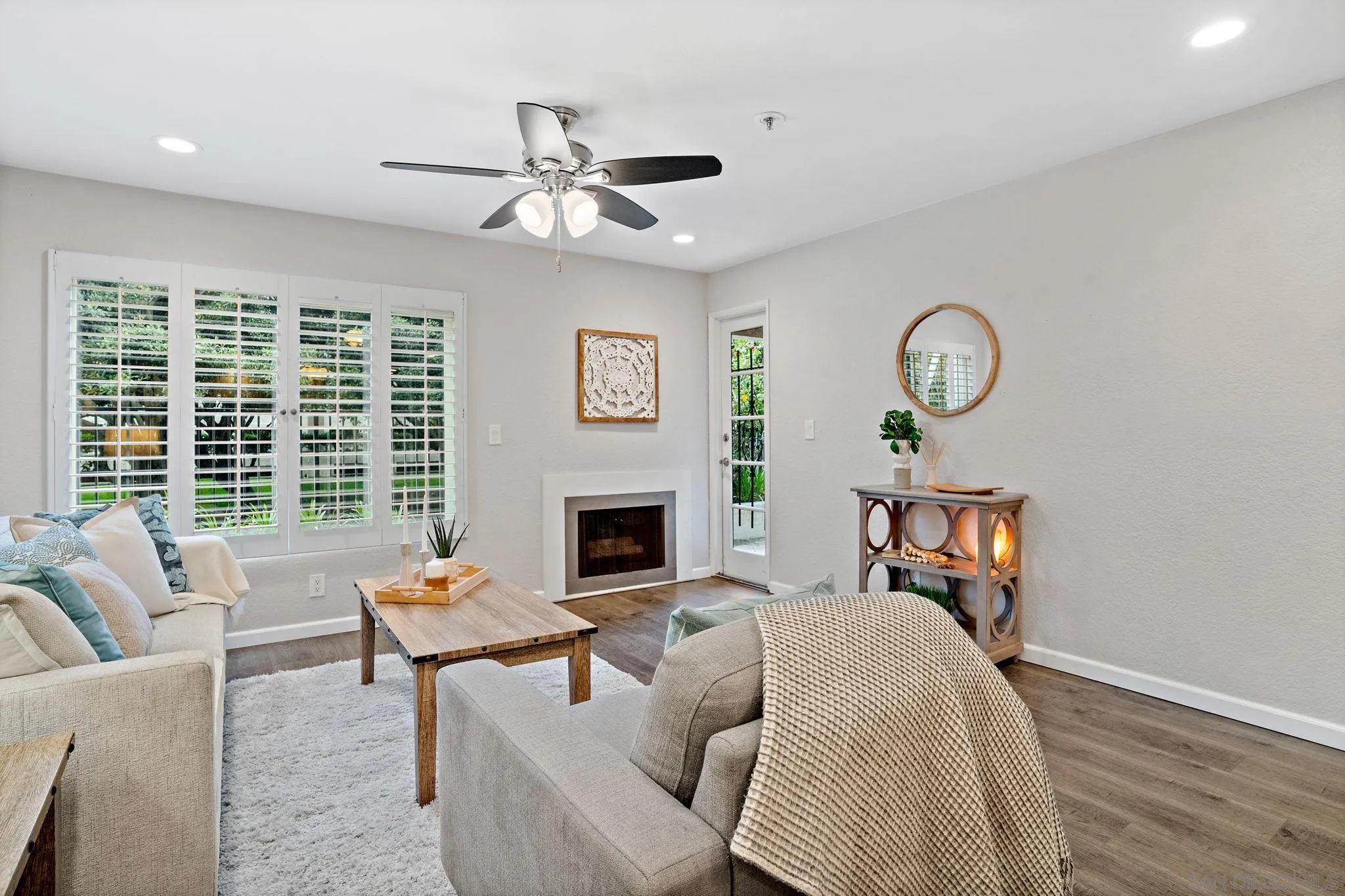 5705 Friars Road, Unit 8 San Diego, CA 92110 - Photo 11 of 26 a living room with furniture a fireplace and a large window