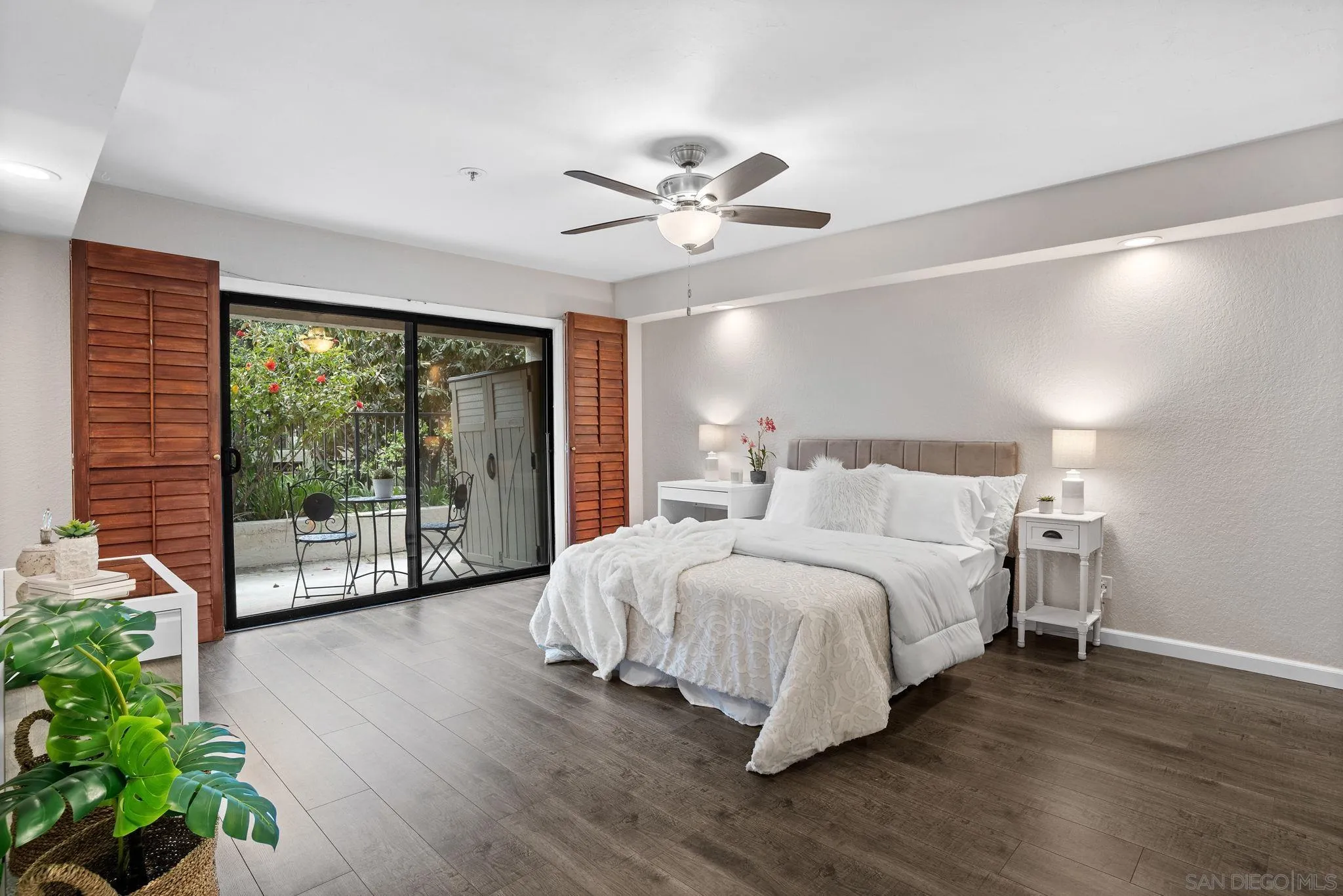 5705 Friars Road, Unit 8 San Diego, CA 92110 - Photo 12 of 26 a spacious bedroom with a large bed and a chandelier