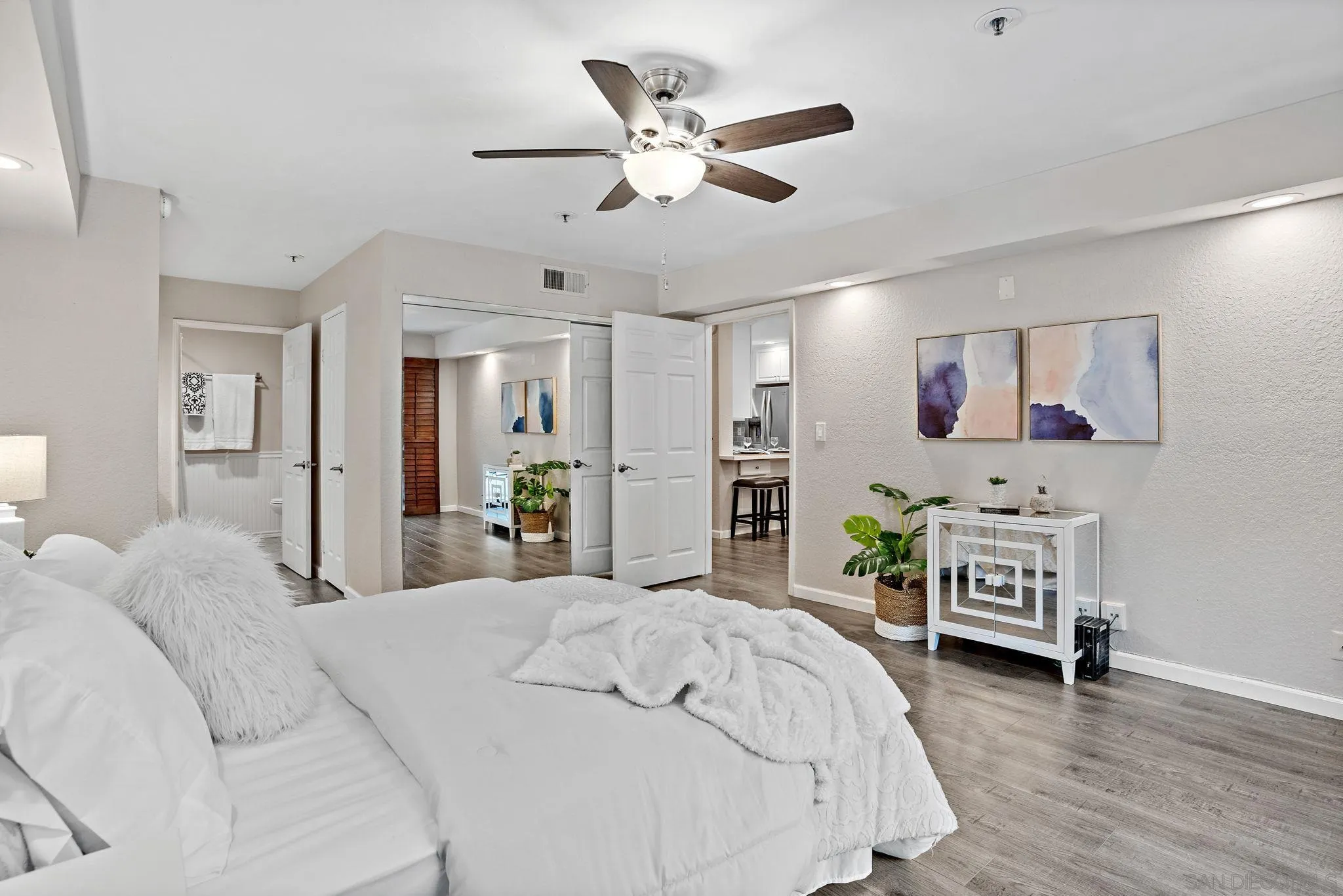 5705 Friars Road, Unit 8 San Diego, CA 92110 - Photo 13 of 26 a bedroom with a bed and a chandelier