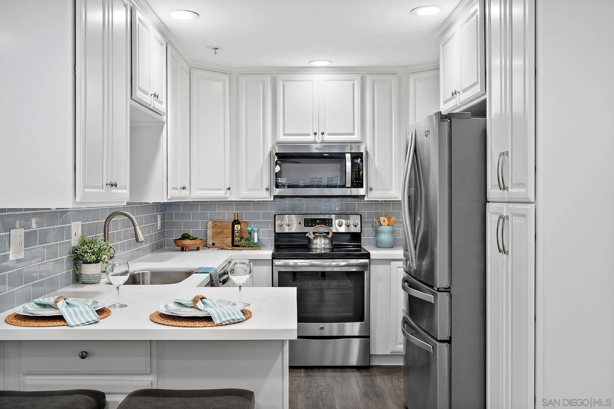 5705 Friars Road, Unit 8 San Diego, CA 92110 - Photo 2 of 26 a kitchen with white cabinets and appliances