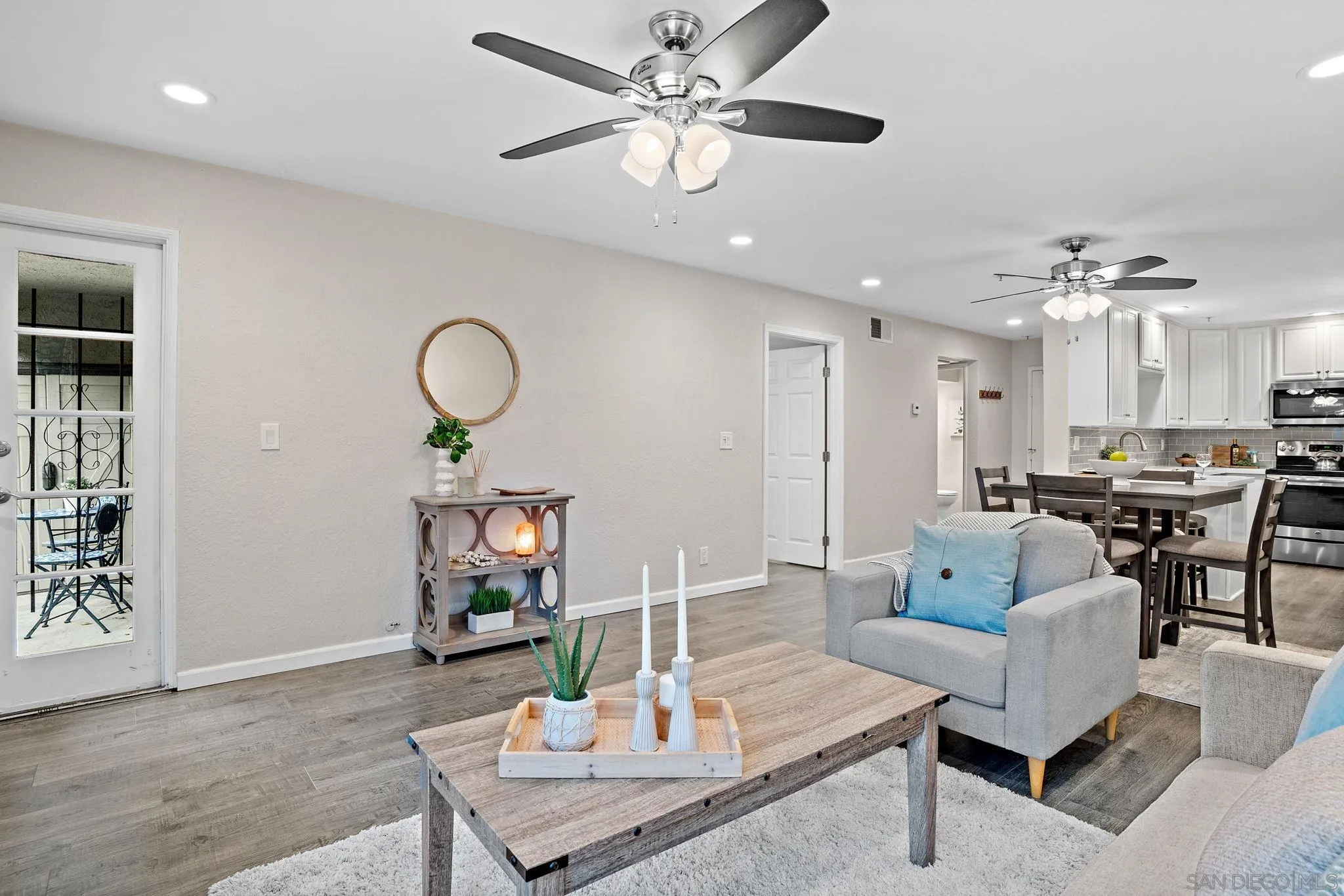 5705 Friars Road, Unit 8 San Diego, CA 92110 - Photo 9 of 26 a living room with furniture kitchen view and a chandelier